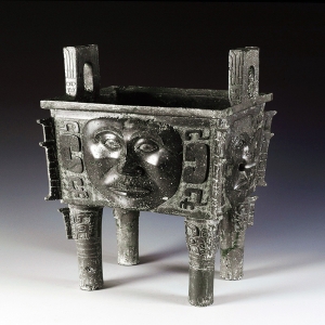 Shang Dynasty (1600 - 1046 BC) Height: 35.5 cm; diameter at the mouth: 28.6cm Unearthed at Huangcai, Ningxiang, Hunan Province in 1959 Bronze ding (food container) with human-mask design