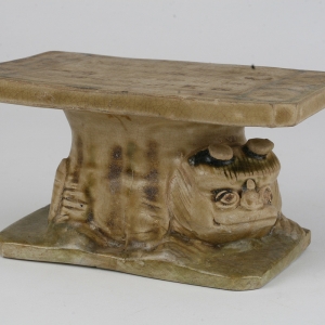 Tang Dynasty Brown and green colored porcelain pillow with lion pedestal and poem design
